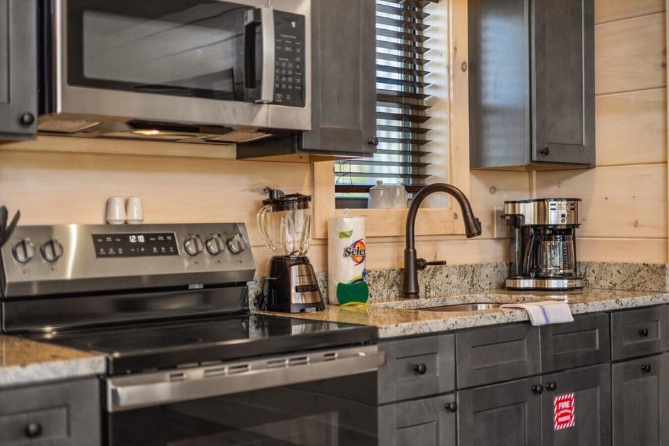 Full kitchen with stove, refrigerator, drip coffee maker