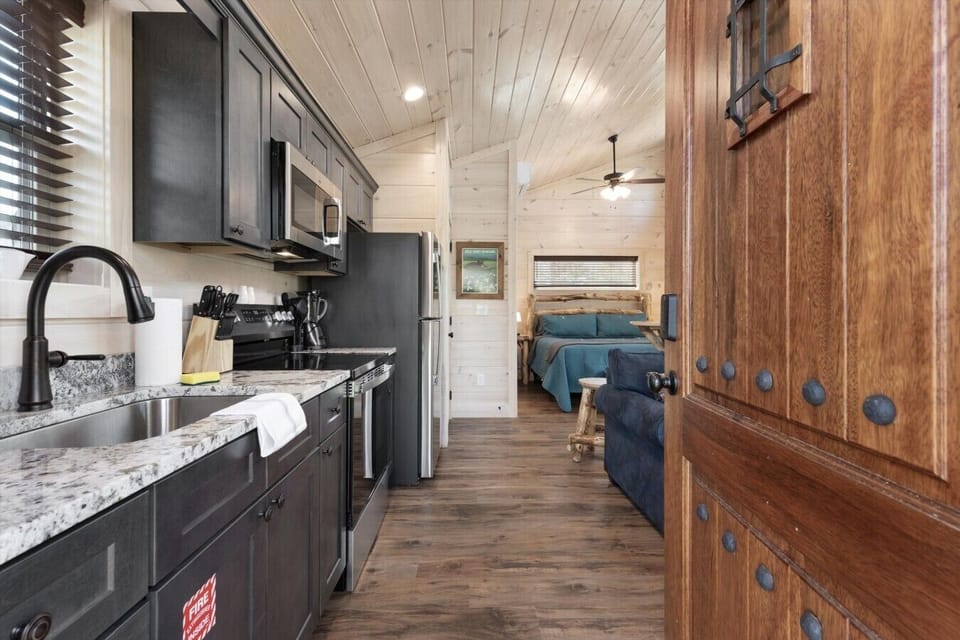 Living space with full kitchen, smart tv, dining, electric fireplace