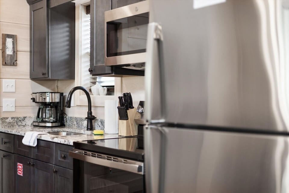 Full kitchen with stove, refrigerator, drip coffee maker