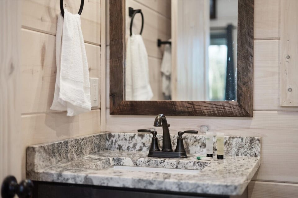 Granite vanity with rustic framed mirror