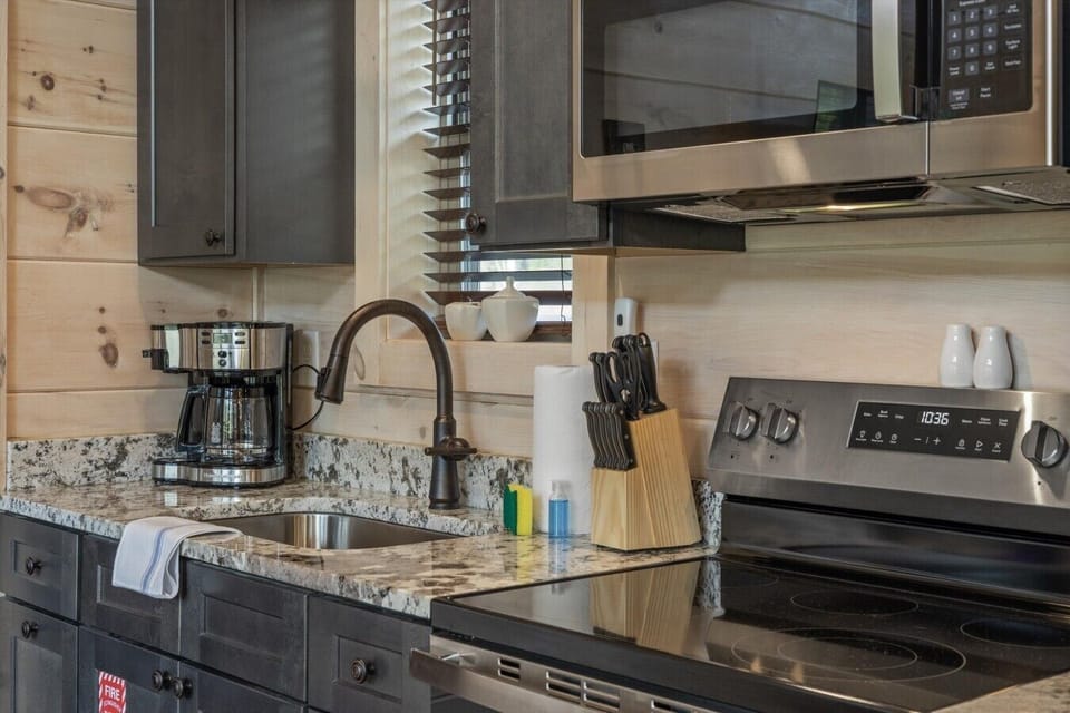 Full kitchen with stove, refrigerator, drip coffee maker