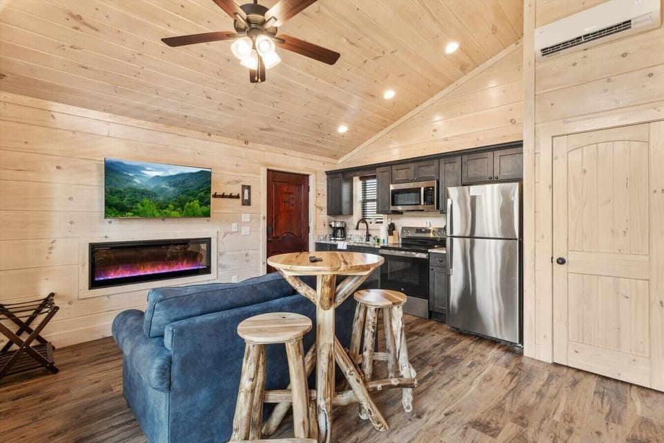Living space with full kitchen, smart tv, dining, electric fireplace