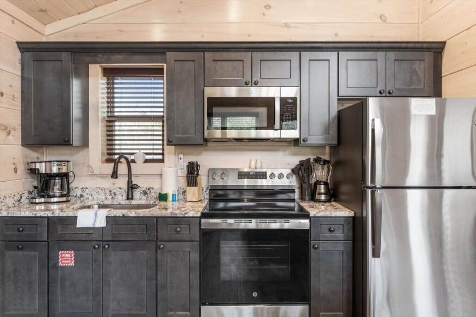 Full kitchen with stove, refrigerator, drip coffee maker
