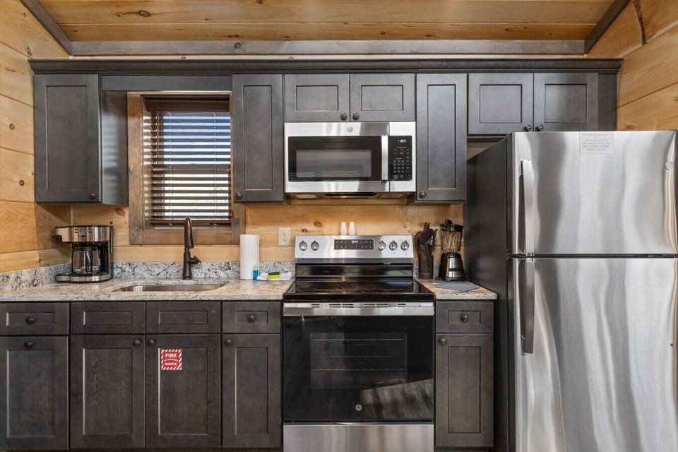 Full kitchen with stove, refrigerator, drip coffee maker