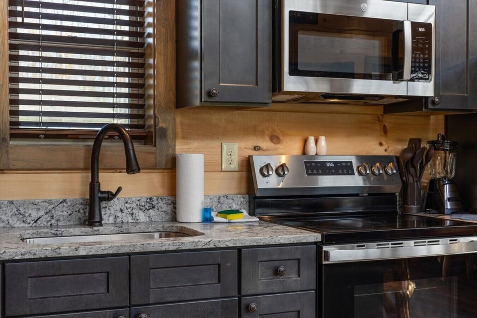 Full kitchen with stove, refrigerator, drip coffee maker