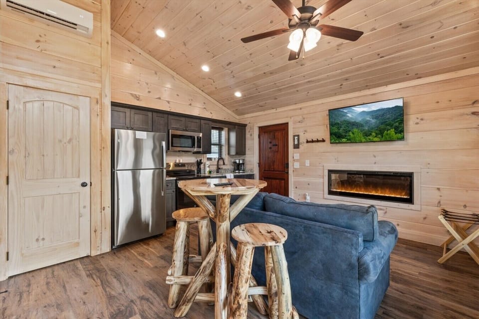 Living space with full kitchen, smart tv, dining, electric fireplace