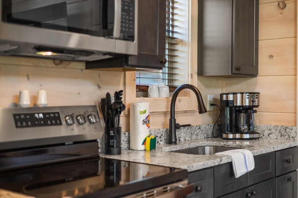 Full kitchen with drip coffee pot, microwave and stove