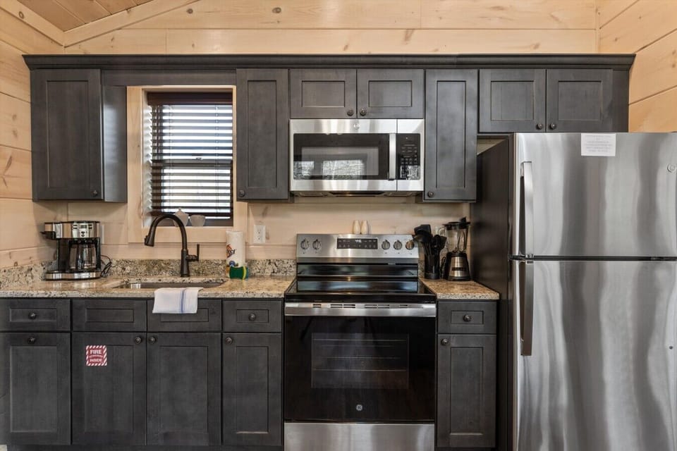 Full kitchen with stove, refrigerator, drip coffee maker