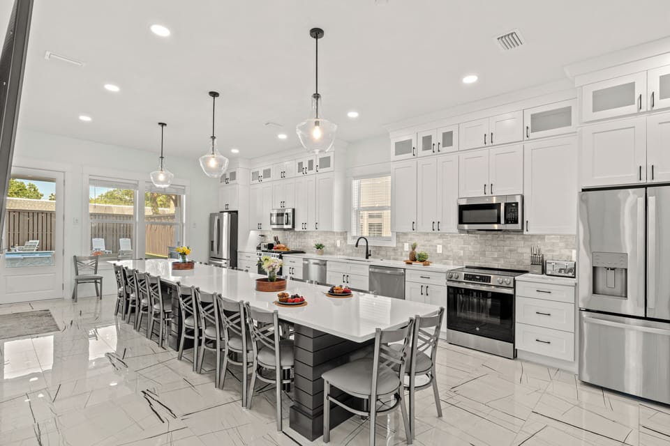 High-end chef's kitchen showcasing an expansive breakfast bar island and premium finishes.