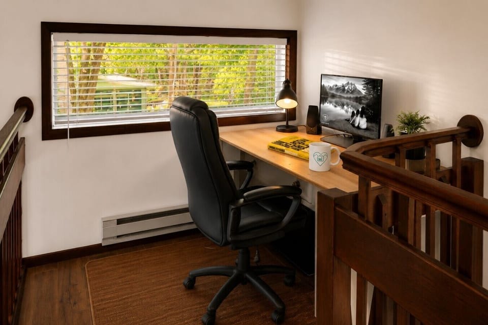 Loft workspace with Smart TV and desk setup, perfect for remote work or a quiet reading spot.