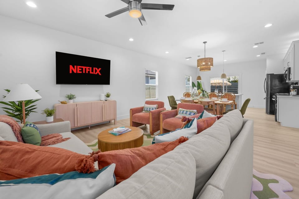 Bright open living space with comfy seating, dining area, and smart TV