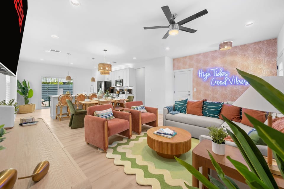 Stylish open living area with coastal flair and fun neon vibes