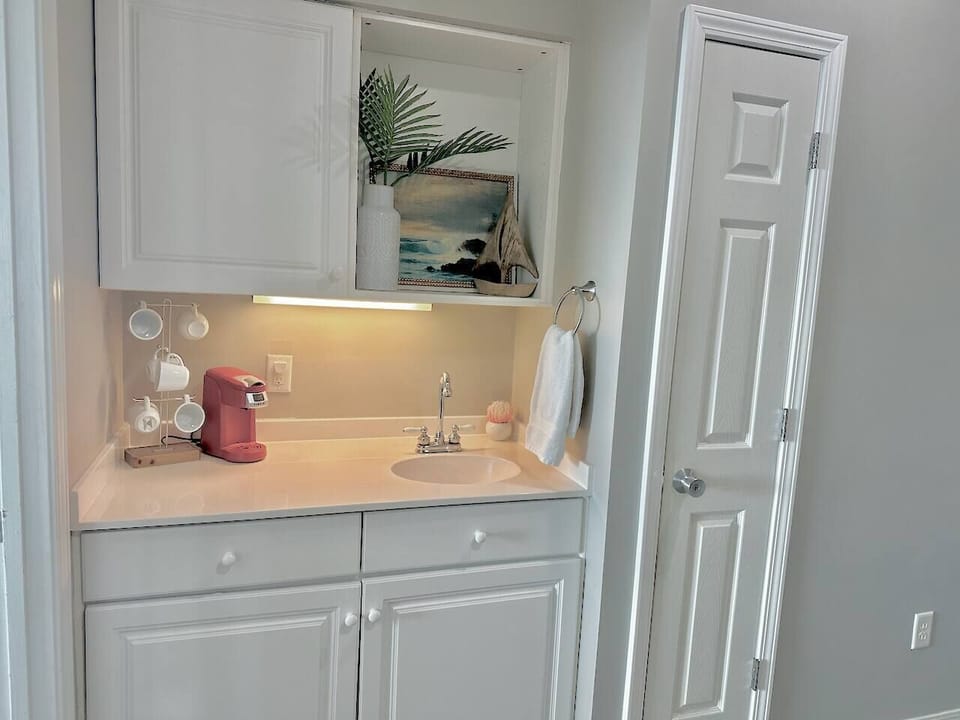Coffee bar upstairs just outside the primary bedroom door.  Enjoy your morning coffee on the private balcony without even having to go downstairs first!