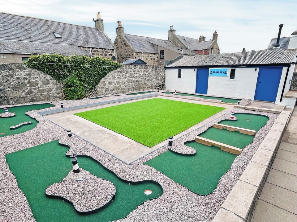 Garden - bike shed/games room, utility room and putting greens | Broadsea Cottage, Fraserburgh