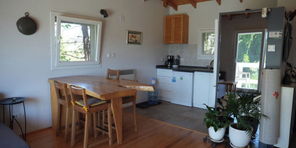A functional kitchen area featuring a wooden dining table and modern appliances.