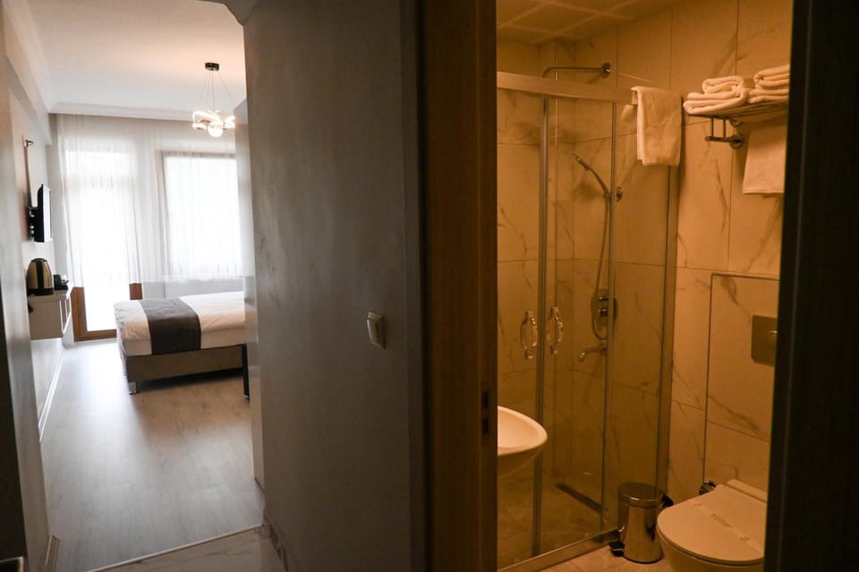 Standard Double Room, Balcony, City View | Bathroom | Shower, rainfall showerhead, hair dryer, slippers