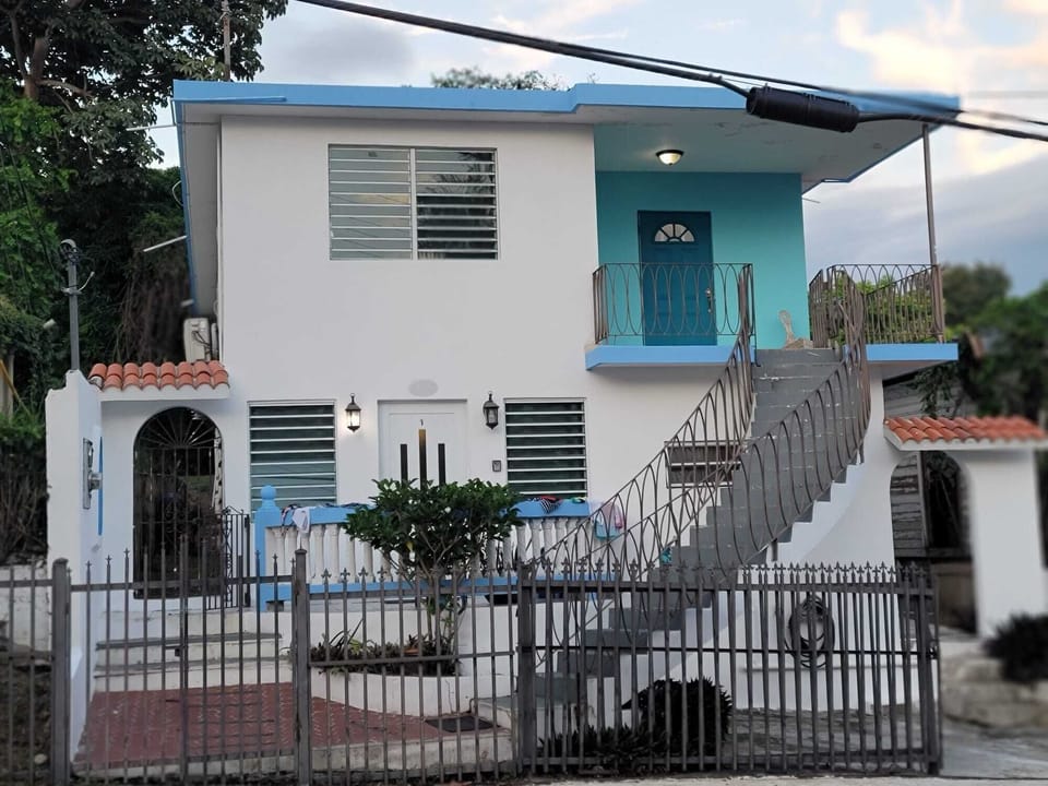 Bright tropical home with gated yard, balcony, and private entry
