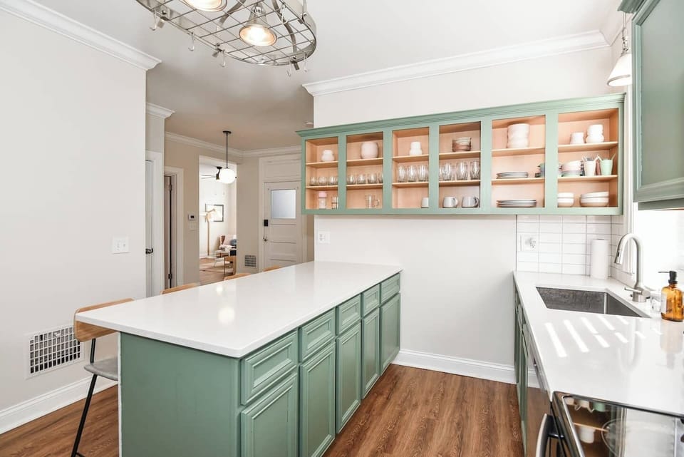 Spacious kitchen island with open shelving and bar seating.