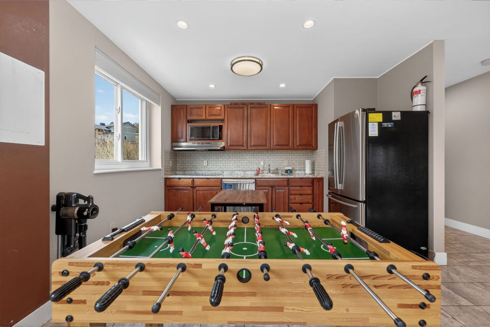 Challenge your friends to a foosball match in this open-concept space where fun meets functionality, complete with a full kitchen for game-day snacks.