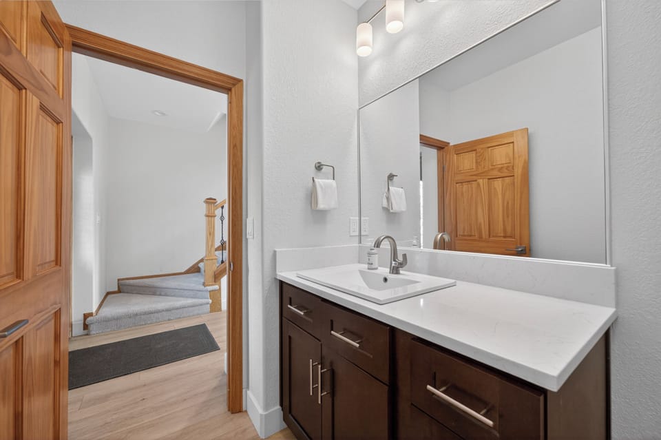 Freshen up at your sleek vanity with bright modern lighting and a spacious mirror—perfect for getting ready before your next adventure.