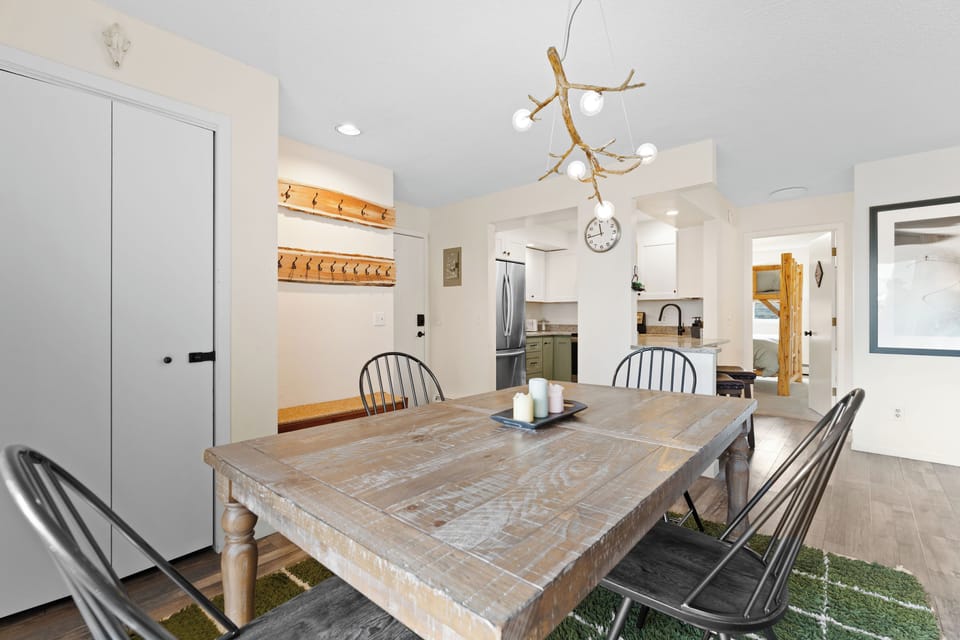 Gather around this rustic dining table where shared meals become cherished memories. The bright, open-plan layout connects you to the well-equipped kitchen, making every moment together effortless and inviting.