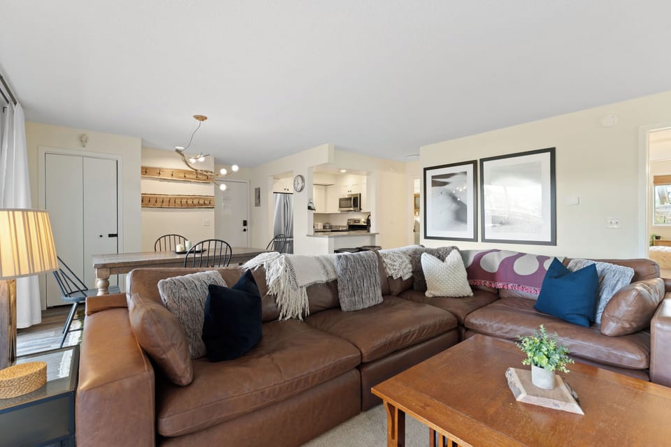Sink into the plush leather sectional and feel at home in this open, light-filled space where cozy living meets a fully-equipped kitchen—perfect for your relaxing getaway.