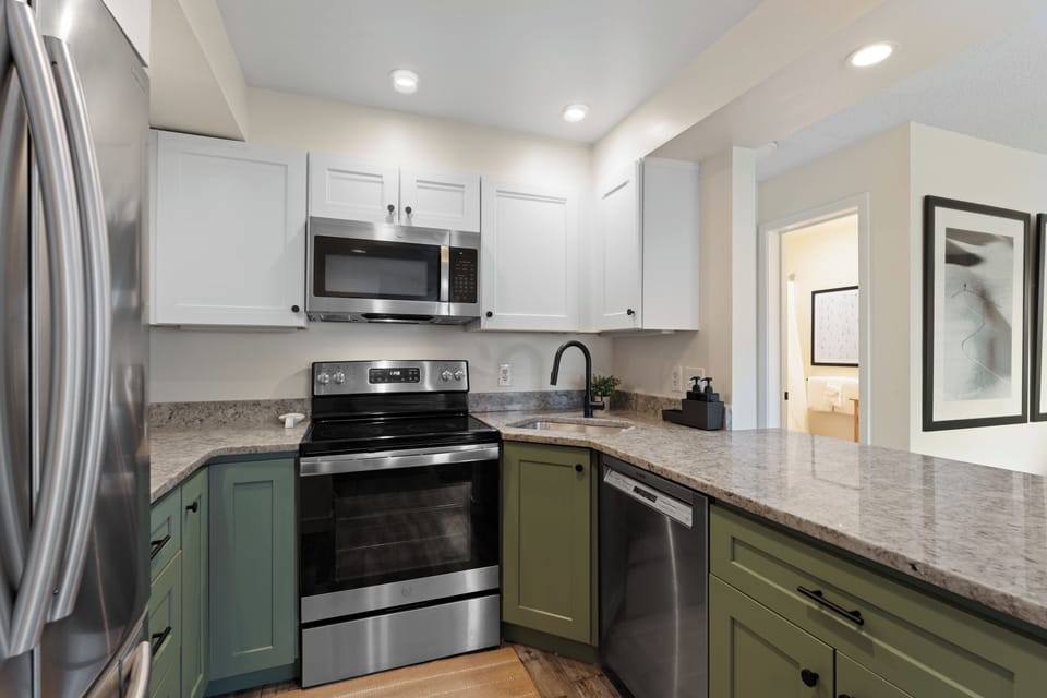 This modern kitchen features stainless steel appliances, granite countertops, and ample storage, making your meal prep convenient and enjoyable.