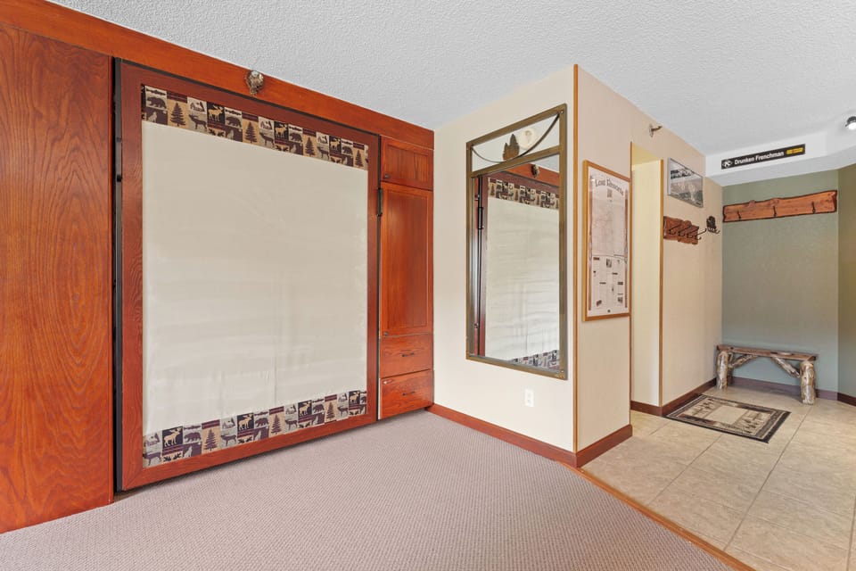 Spacious entrance area with rich wood accents and convenient storage, setting a warm and welcoming tone from the moment you arrive.