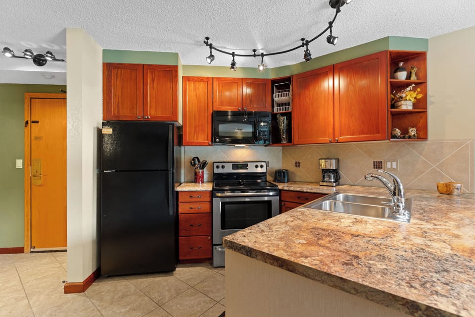 Your fully-equipped kitchen features granite counters, cherry cabinets, and modern appliances—perfect for preparing meals during your stay.