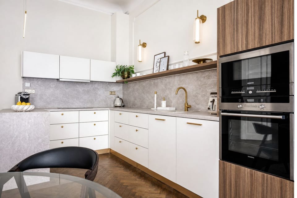 Bright designer kitchen with brass accents and built-in double ovens