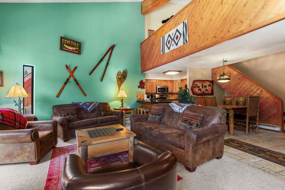 Unwind in your cozy mountain retreat with leather seating, rustic wood beams, and charming ski lodge décor that welcomes you home after a day of adventure.