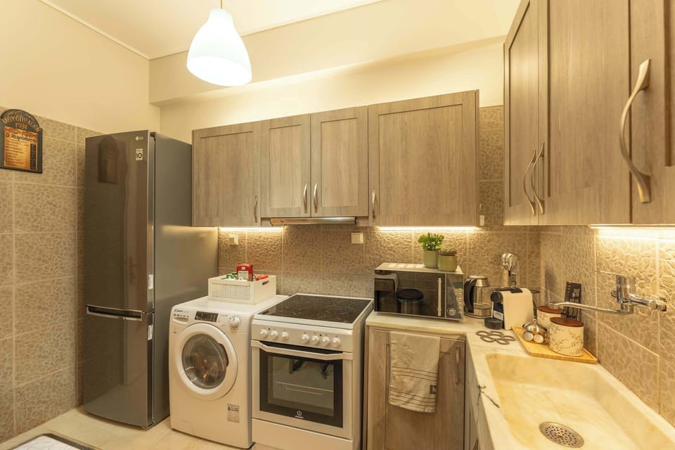 A well-appointed kitchen with contemporary cabinetry and full amenities, designed for effortless longer stays by Marina Zeas.