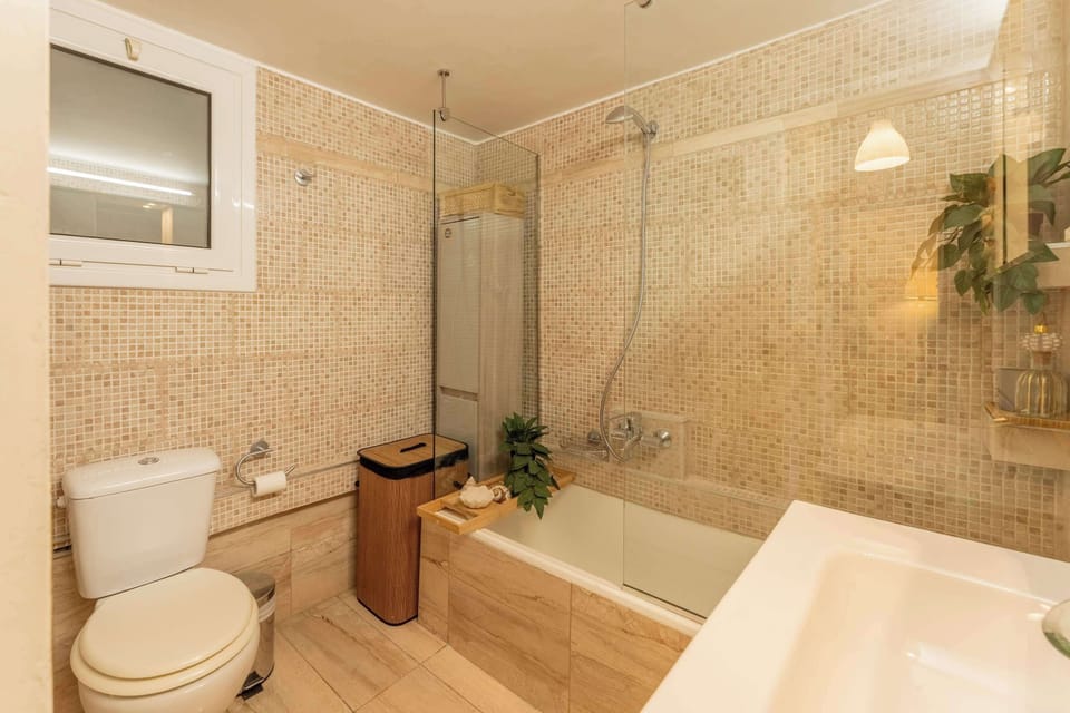 A bright, well-finished bathroom with clean lines and natural tones, offering comfort and ease throughout the stay.