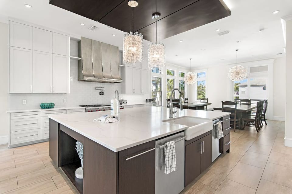Fully equipped kitchen with large double-sided kitchen island for meal prep.