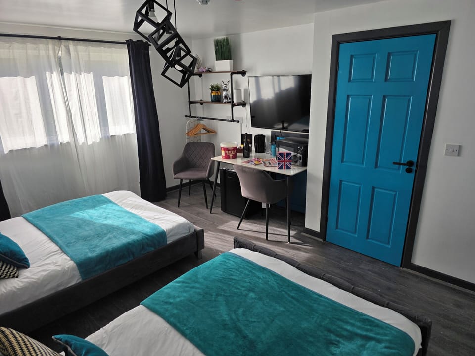 Deluxe Double or Twin Room | Desk, laptop workspace, blackout drapes, iron/ironing board