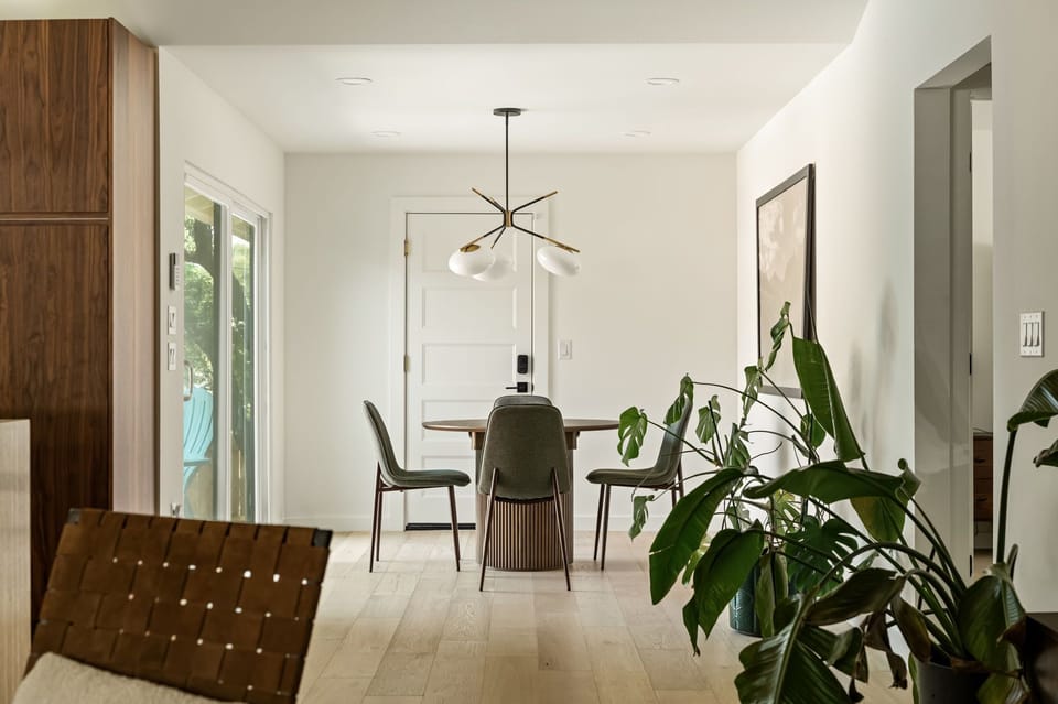 Bright modern dining nook with designer lighting and natural light