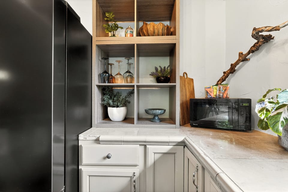 Stylish kitchen nook with custom shelving and convenient prep space