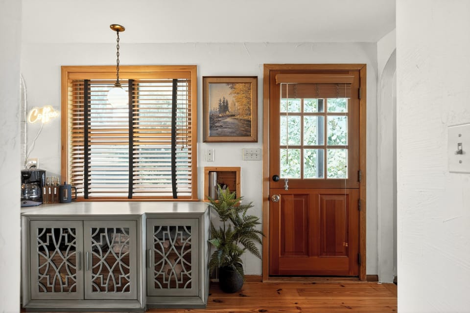 Bright, welcoming entryway with warm wood accents and stylish decor