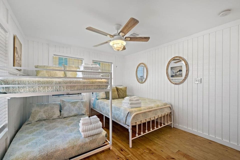 This bedroom has a queen bed and a full bunk bed