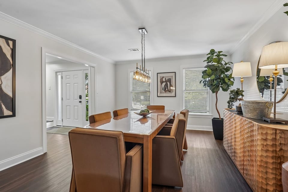 Dining Room - Sleek minimally styled for functionality and comfortable dining; this space can also serve as a work space or family game time. +Sideboard +Storage +Highchair  +board games 