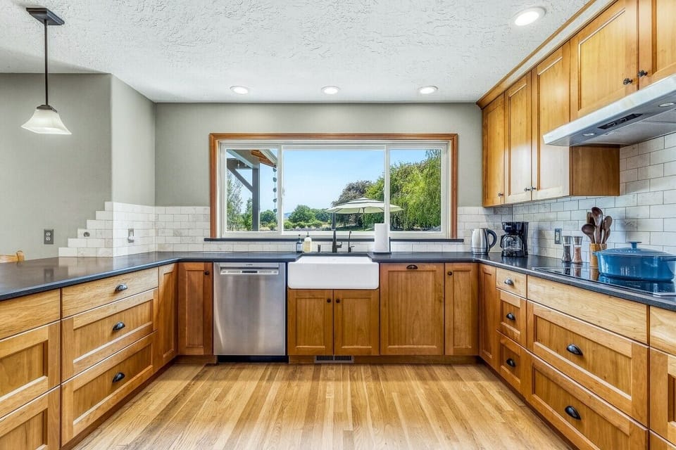 he well-equipped kitchen offers backyard views and space for group meals.