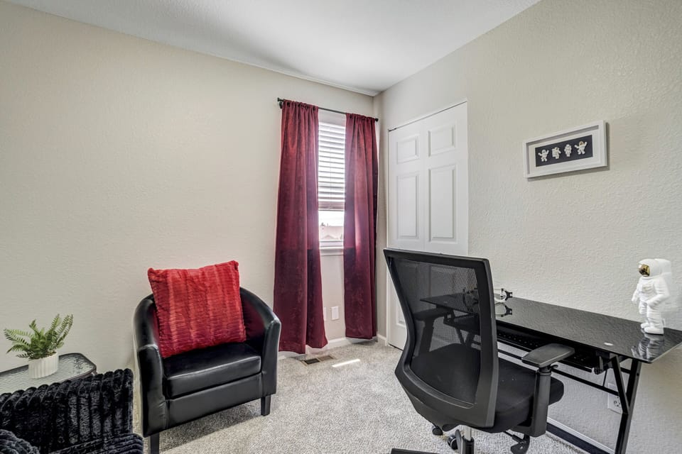 The third bedroom serves as a quiet workspace with a desk and chair, making it ideal for remote workers and traveling professionals.