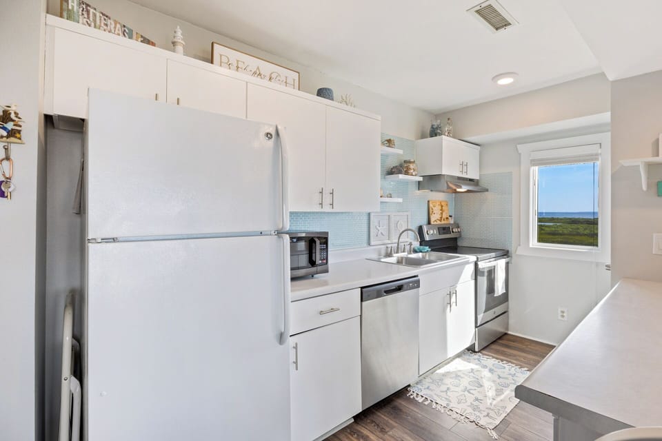 The fully equipped kitchen makes preparing vacation meals simple and convenient.