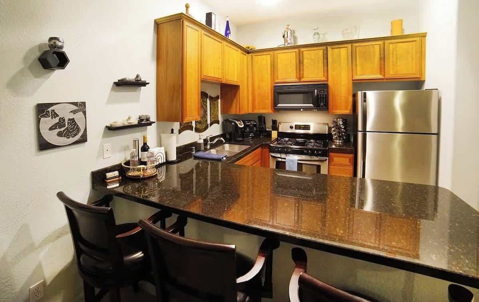 The kitchen island offers the perfect spot for casual meals, morning coffee, or conversation