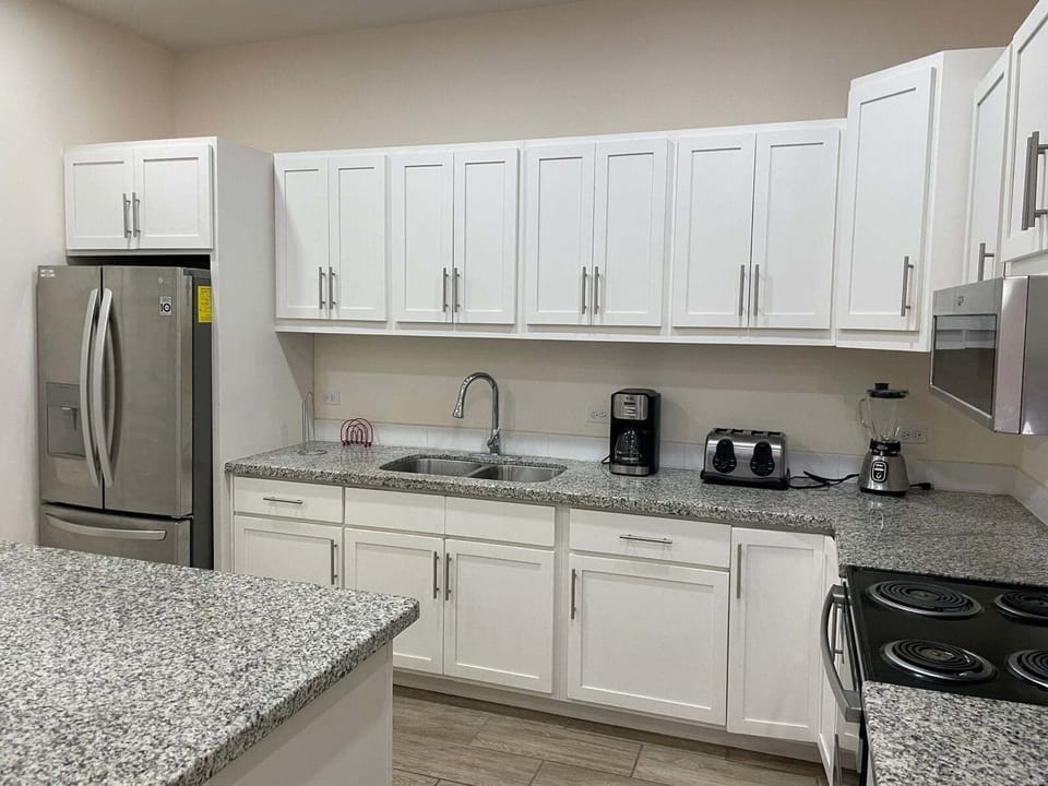 An interior close-up view of the kitchen inside La Kasa #1, highlighting the fully equipped cooking space stocked with essential utensils, cookware, and modern countertop appliances for guest use.