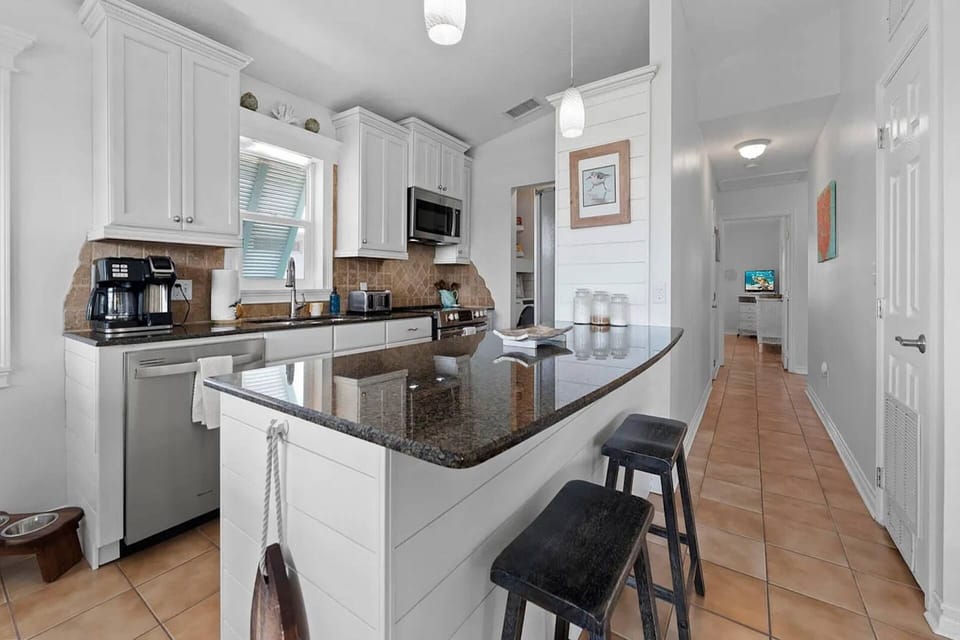 The spacious kitchen with island seating makes meal prep, snacks, and conversation easy for everyone.
