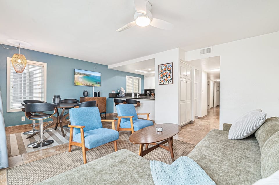 Open-concept living area featuring comfortable seating and a bright, welcoming atmosphere
                