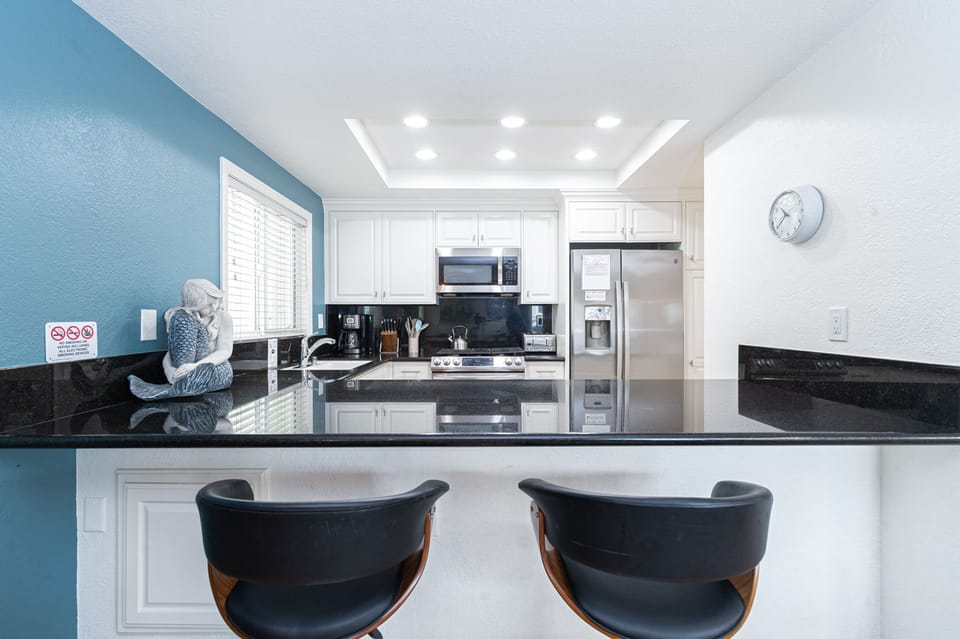 Spacious kitchen with recessed lighting, ample prep space, and modern finishes throughout
                