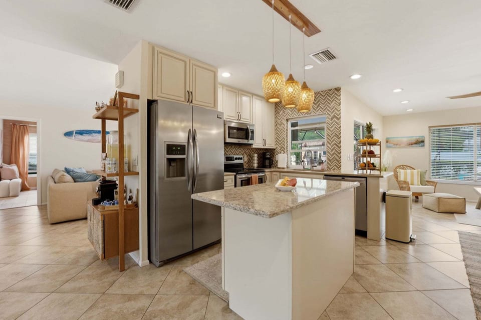 A full professional kitchen — island seating, all the appliances, and the open-plan flow that makes group cooking actually enjoyable.