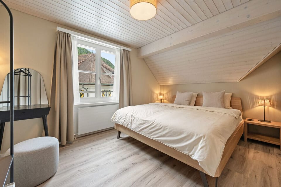 Drift into restful sleep in your cozy bedroom featuring a king-size bed (180x200 cm), soft lighting, calming tones, and a dedicated vanity space to get ready with ease.